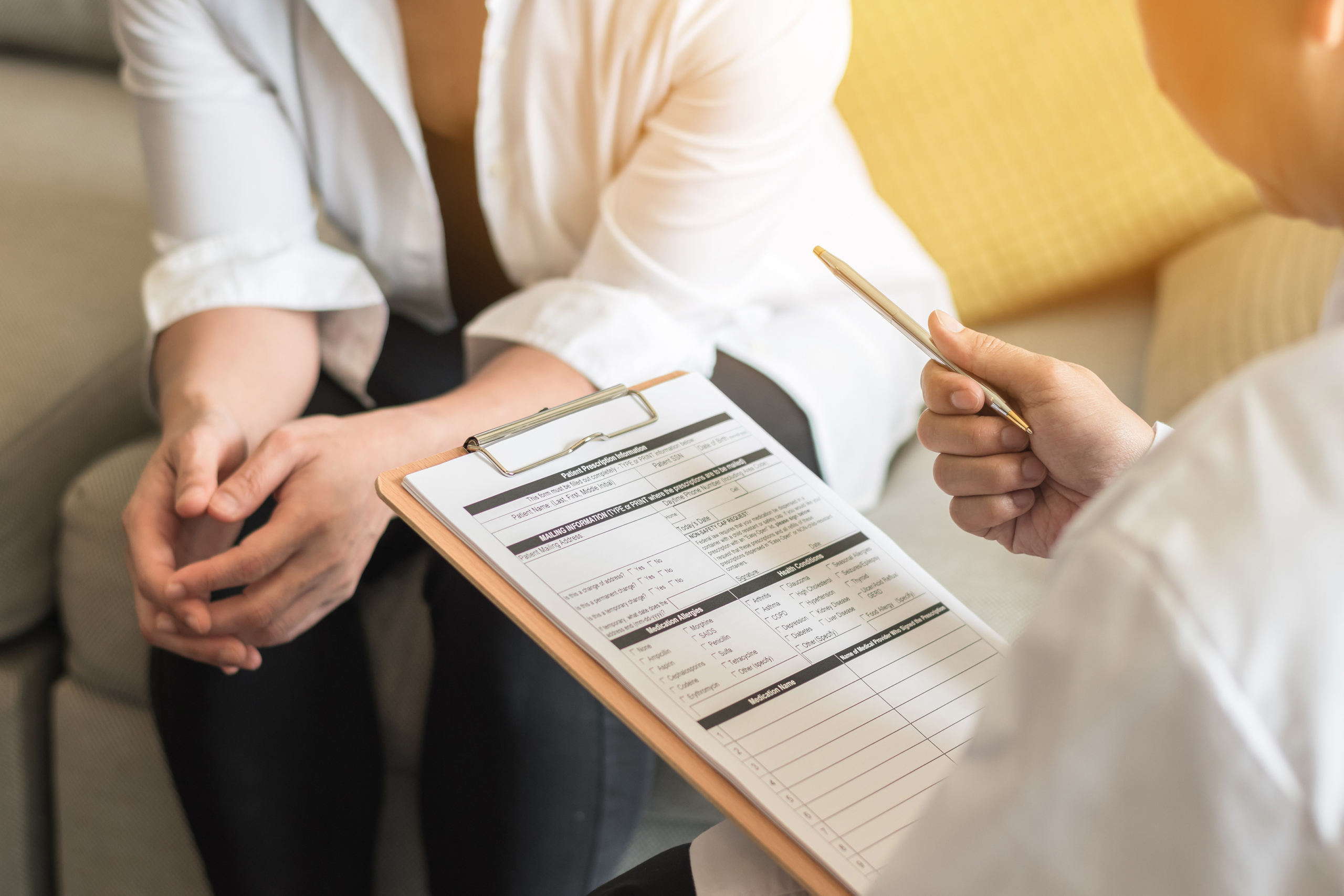 Doctor (gynecologist or psychiatrist) consulting and examining woman patient's health in medical clinic or hospital health service center